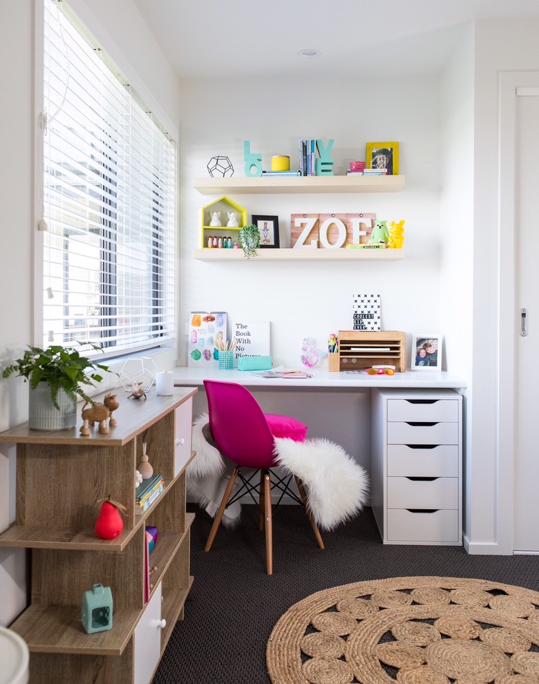 Photo of a beach style kids' study room for kids 4-10 years old and girls in Other with white walls, carpet and grey floor.