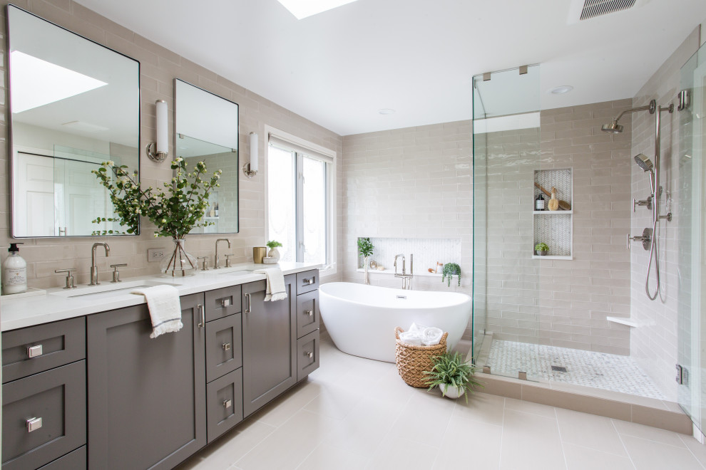 Inspiration for a mid-sized transitional master gray tile and ceramic tile porcelain tile and double-sink freestanding bathtub remodel in Seattle with shaker cabinets, gray cabinets, an undermount sink, quartz countertops, a hinged shower door, white countertops and a built-in vanity