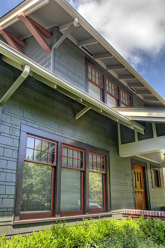 Inspiration for a large arts and crafts two-storey grey exterior in Seattle with wood siding.