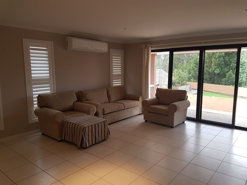 Photo of a large transitional open concept living room in Brisbane with porcelain floors and no tv.
