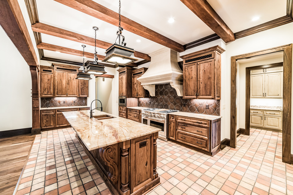 Large mountain style u-shaped terra-cotta tile and multicolored floor eat-in kitchen photo with an undermount sink, raised-panel cabinets, dark wood cabinets, onyx countertops, brown backsplash, terra-cotta backsplash, stainless steel appliances, an island and beige countertops