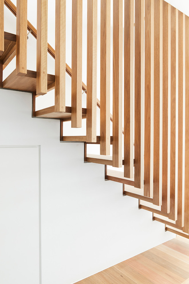 Design ideas for a mid-sized modern wood l-shaped staircase in Melbourne with wood risers and wood railing.