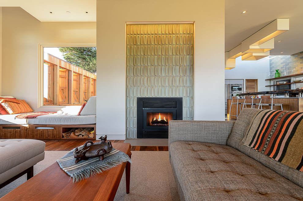 Design ideas for a contemporary formal open concept living room in San Francisco with white walls, medium hardwood floors, a standard fireplace, a tile fireplace surround and no tv.