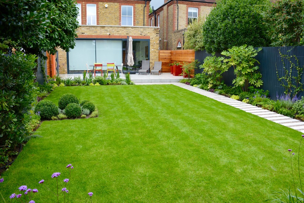 This is an example of a medium sized contemporary back full sun garden for summer in London.