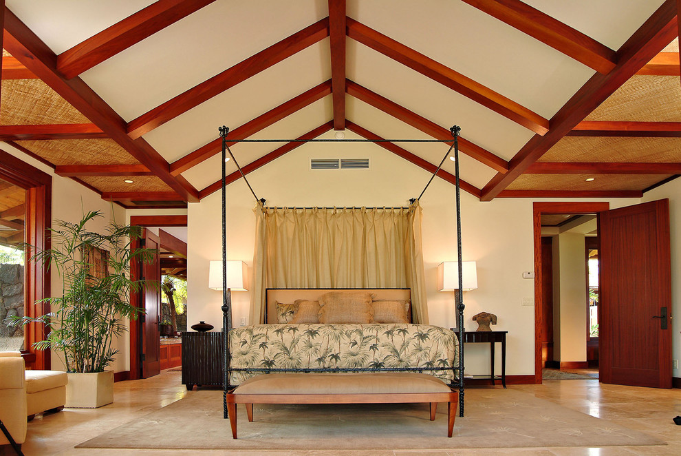 Inspiration for a tropical bedroom in Hawaii with travertine floors.