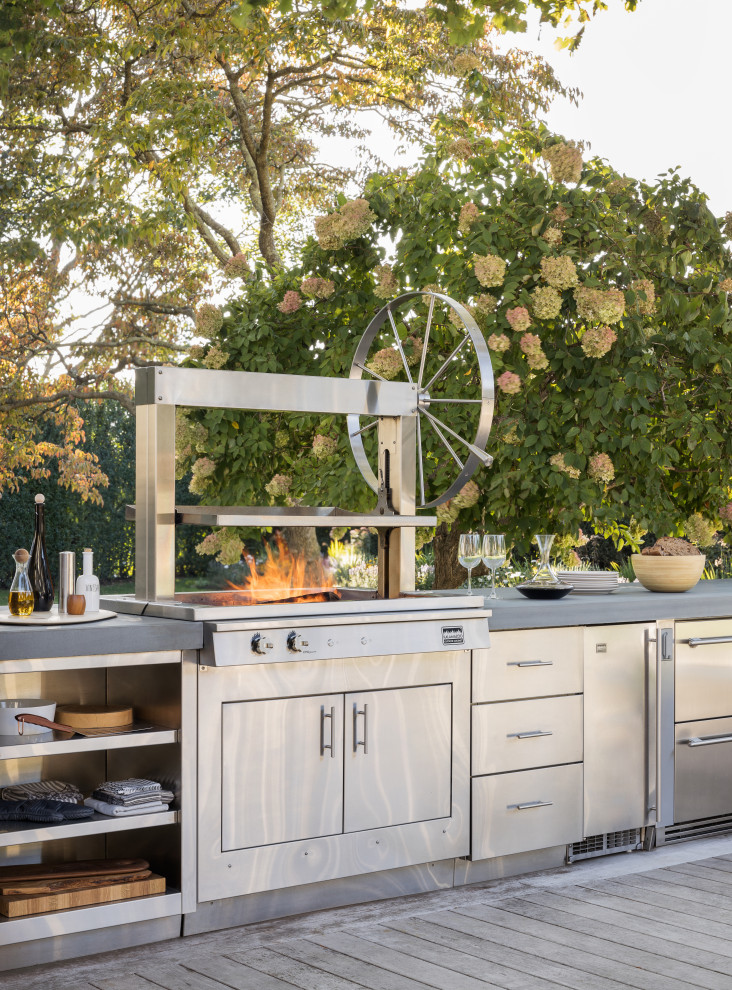 Inspiration for a mid-sized transitional single-wall eat-in kitchen remodel in New York with stainless steel cabinets, concrete countertops, stainless steel appliances, an island and gray countertops