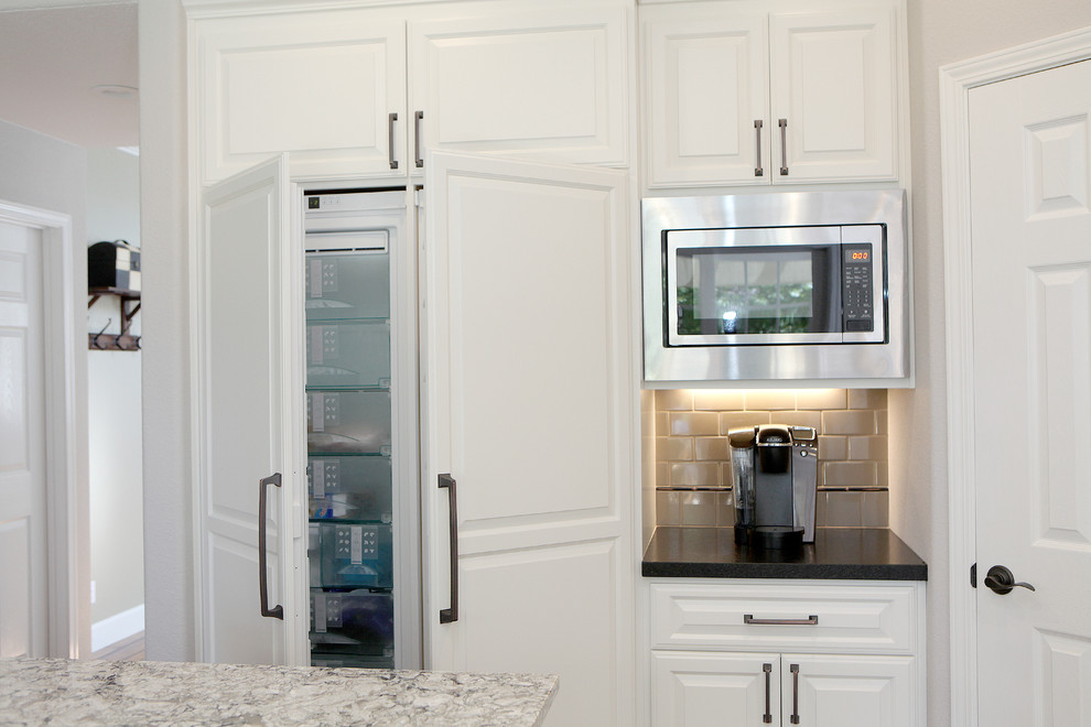 Eat-in kitchen - transitional eat-in kitchen idea in Sacramento with a single-bowl sink, white cabinets, solid surface countertops and stainless steel appliances