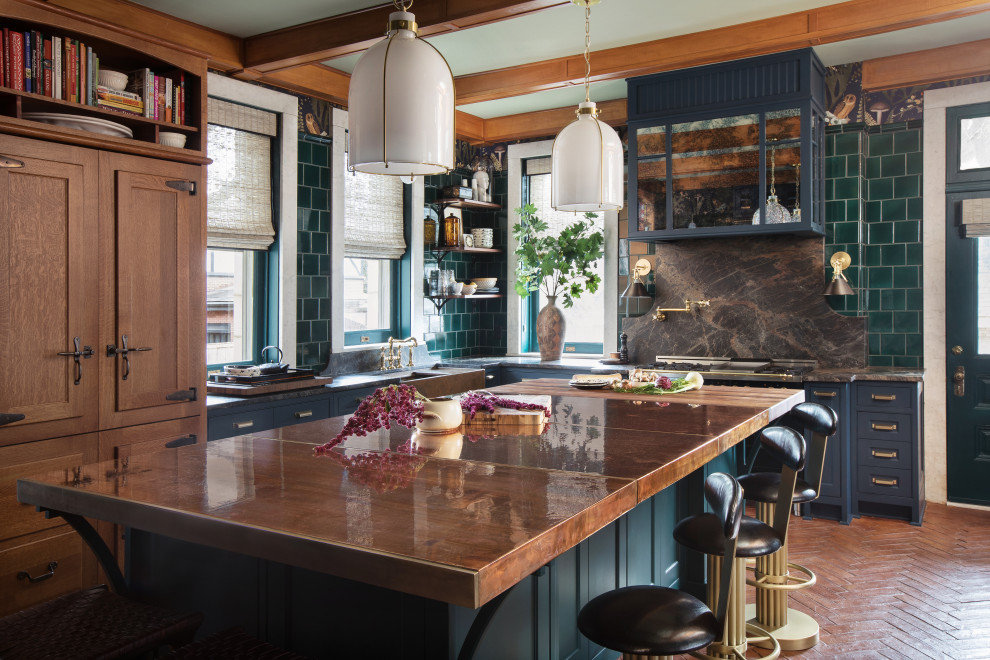 Inspiration for an expansive eclectic l-shaped kitchen in St Louis with recessed-panel cabinets, blue cabinets, brown splashback, ceramic splashback, black appliances, terra-cotta floors, with island, brown benchtop and copper benchtops.