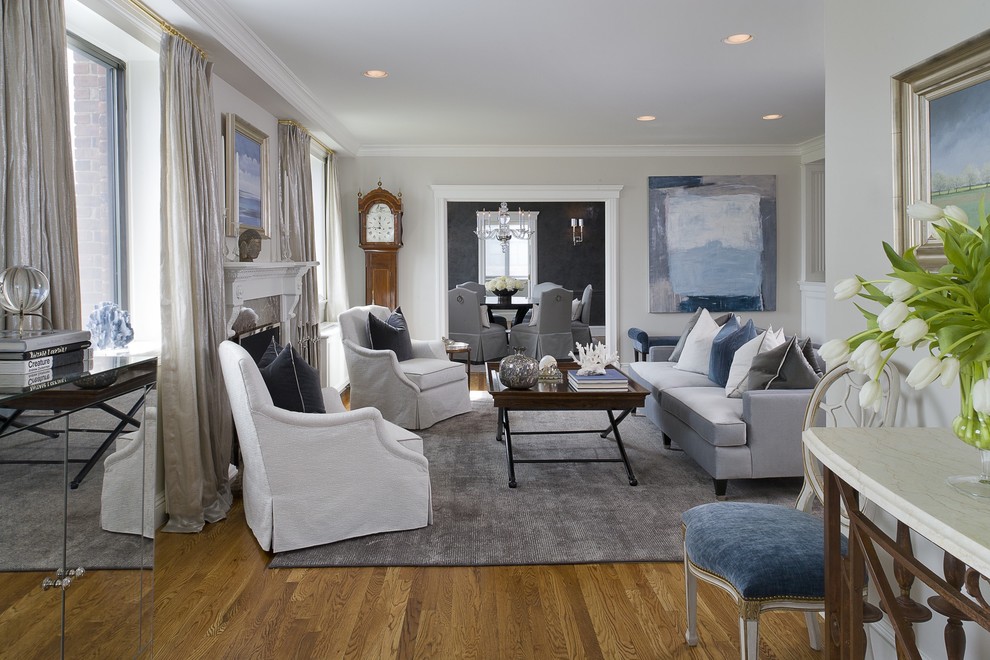 Photo of a mid-sized transitional formal enclosed living room in New York with grey walls, medium hardwood floors, a standard fireplace, no tv and a stone fireplace surround.