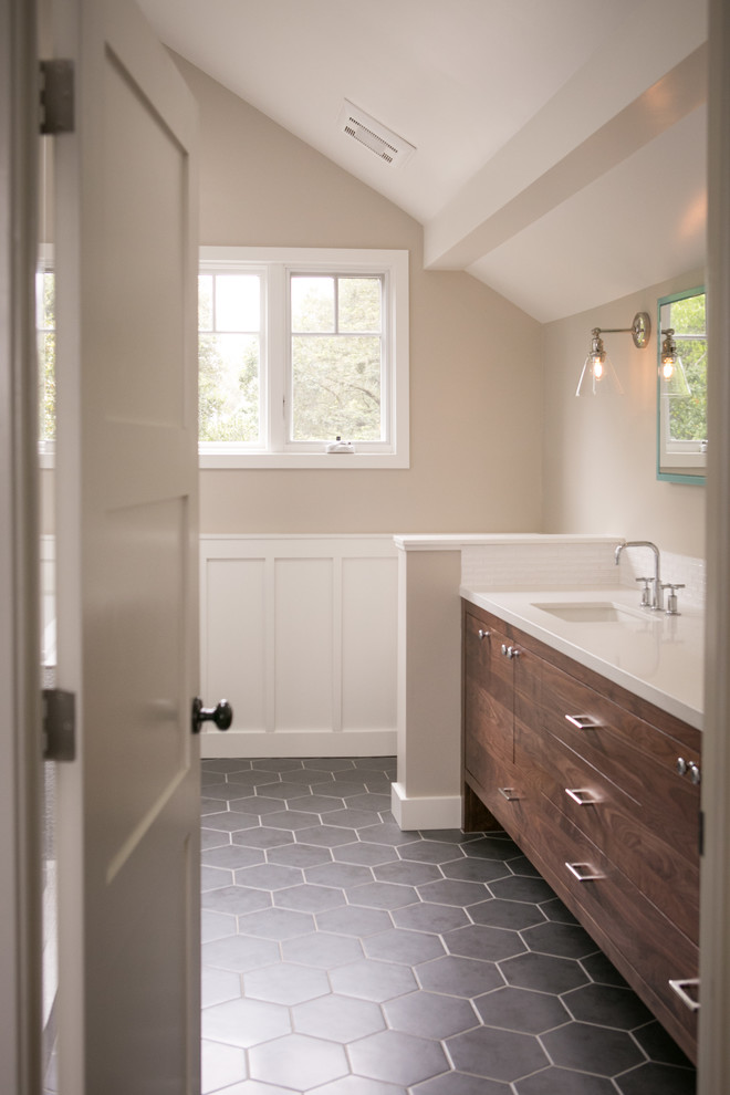 This is an example of a large country master bathroom in San Francisco with flat-panel cabinets, dark wood cabinets, a drop-in tub, a corner shower, a two-piece toilet, gray tile, ceramic tile, beige walls, porcelain floors, an undermount sink, engineered quartz benchtops and black floor.