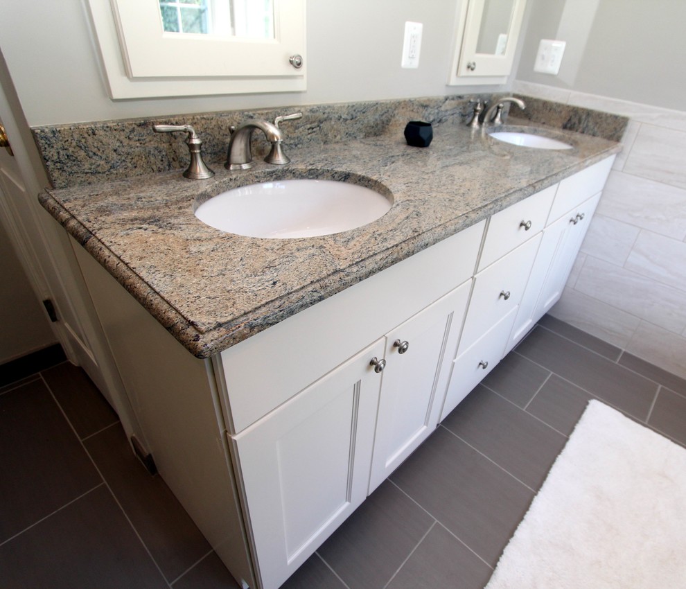 Design ideas for a mid-sized transitional master bathroom in DC Metro with an undermount sink, flat-panel cabinets, white cabinets, granite benchtops, a freestanding tub, a corner shower, a two-piece toilet, brown tile, porcelain tile, grey walls and porcelain floors.