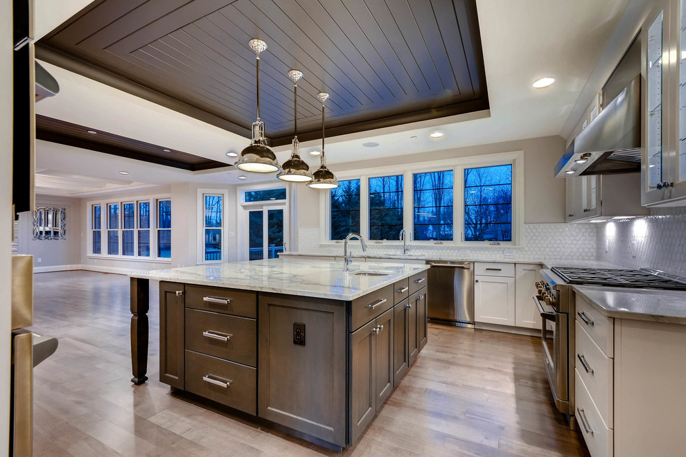 Open concept kitchen - large transitional u-shaped open concept kitchen idea in Baltimore with a single-bowl sink, shaker cabinets, white cabinets, marble countertops, white backsplash, stainless steel appliances and an island