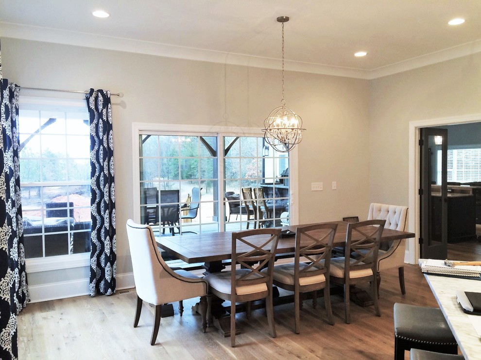 Design ideas for a large contemporary kitchen/dining combo in Charlotte with grey walls and light hardwood floors.
