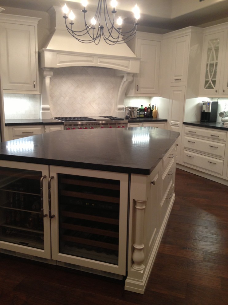 Inspiration for a transitional dark wood floor kitchen remodel in Phoenix with white cabinets, granite countertops, white backsplash, stainless steel appliances and an island