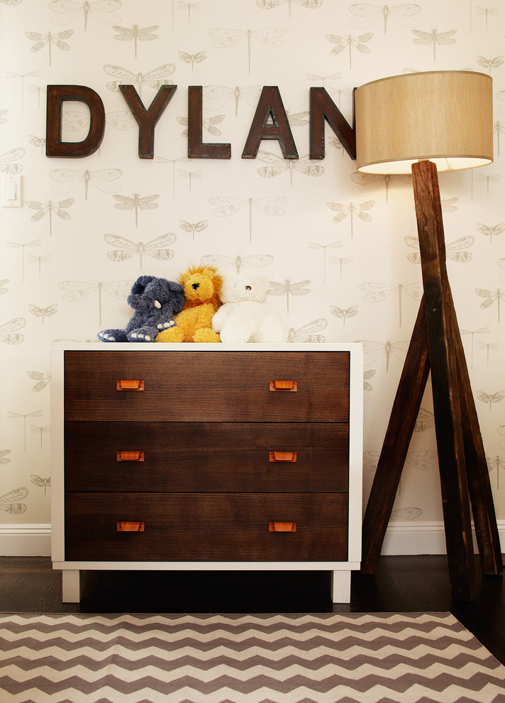 This is an example of a mid-sized transitional kids' room for boys in San Francisco with beige walls and dark hardwood floors.