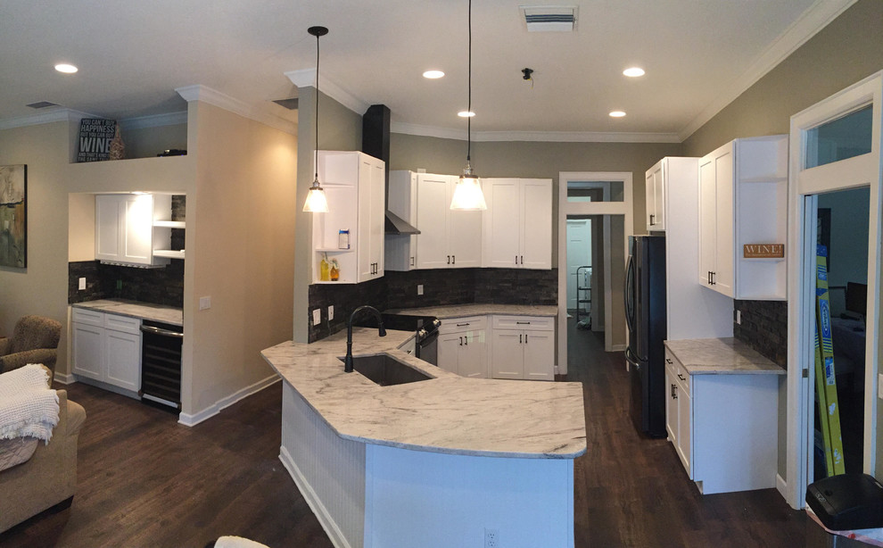 Large transitional u-shaped dark wood floor and brown floor enclosed kitchen photo in Tampa with shaker cabinets, white cabinets, marble countertops, black backsplash, cement tile backsplash, no island and black appliances