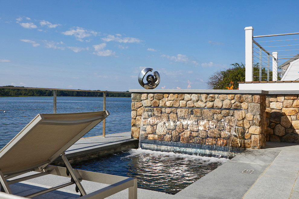 Small beach style backyard stone and rectangular aboveground hot tub photo in New York