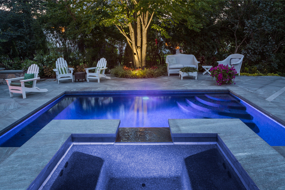 Small traditional side yard rectangular lap pool in Portland Maine with a hot tub and natural stone pavers.