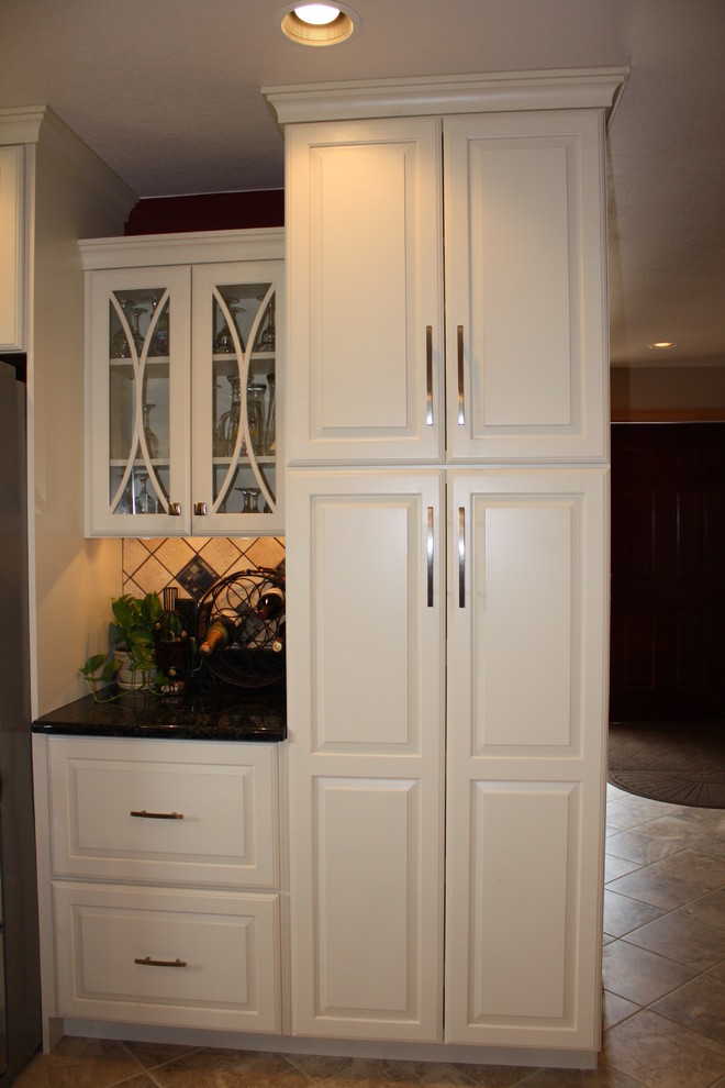 U-shaped ceramic tile eat-in kitchen photo in Denver with open cabinets, white cabinets, an island, a farmhouse sink, quartz countertops, white backsplash and stainless steel appliances