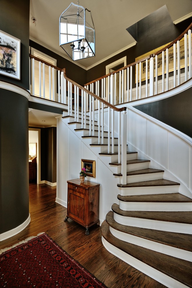 Design ideas for a traditional wood curved staircase in Seattle with painted wood risers.