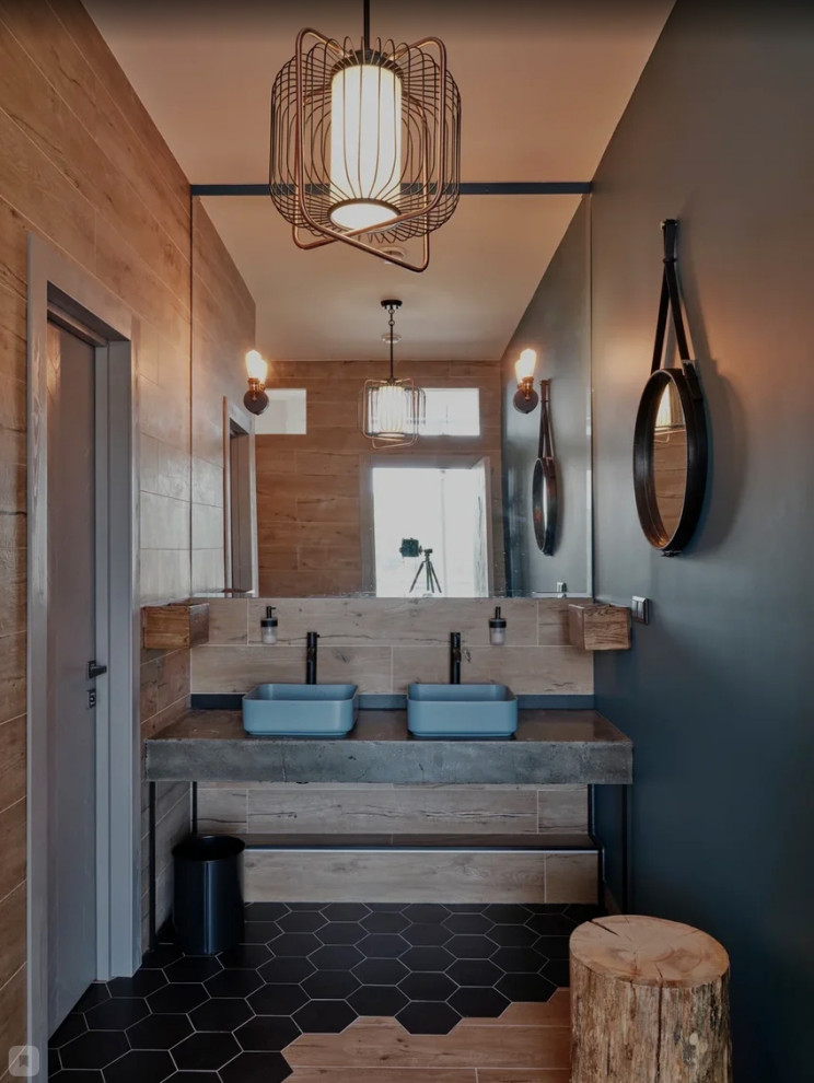 Photo of a mid-sized industrial bathroom in Moscow with grey cabinets, an alcove tub, beige tile, porcelain tile, blue walls, a vessel sink, concrete benchtops, black floor, grey benchtops, an enclosed toilet, a double vanity and a freestanding vanity.