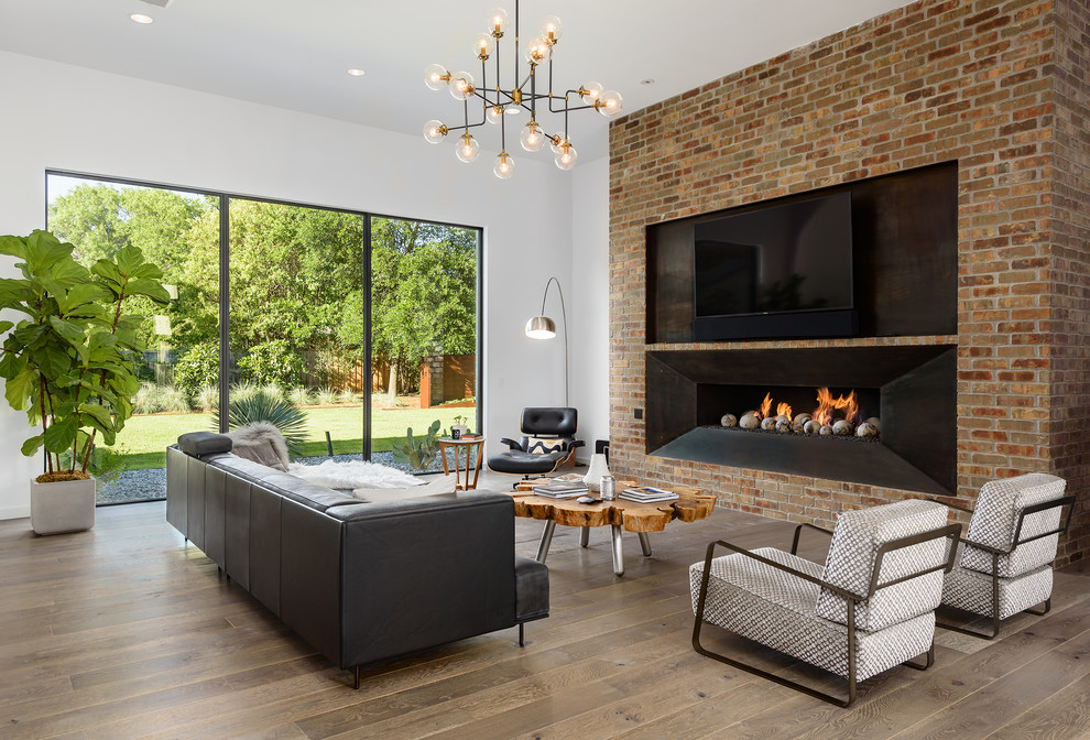 Contemporary living room in Dallas with white walls, dark hardwood floors, a ribbon fireplace, a metal fireplace surround and brown floor.