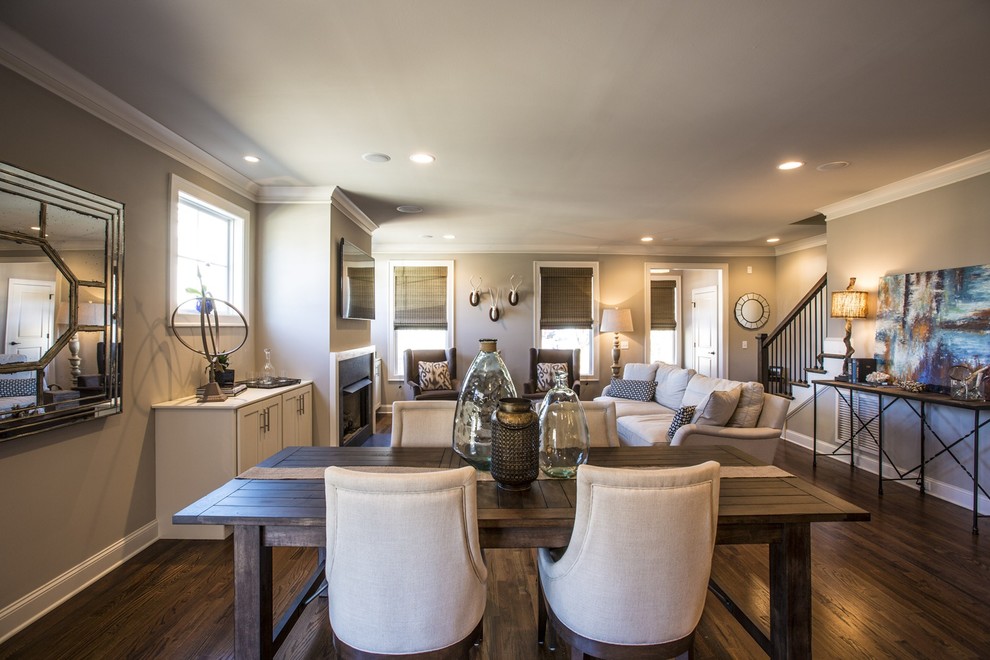 Inspiration for a mid-sized transitional medium tone wood floor and brown floor great room remodel with beige walls, a standard fireplace and a tile fireplace