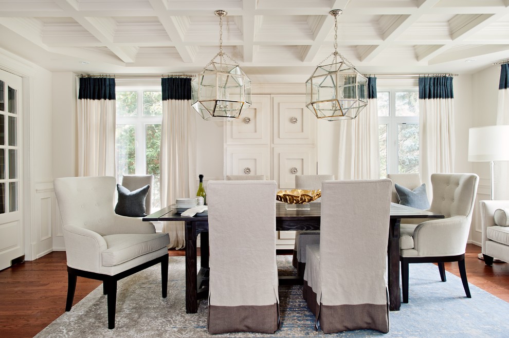 Example of a transitional medium tone wood floor dining room design in Toronto with white walls