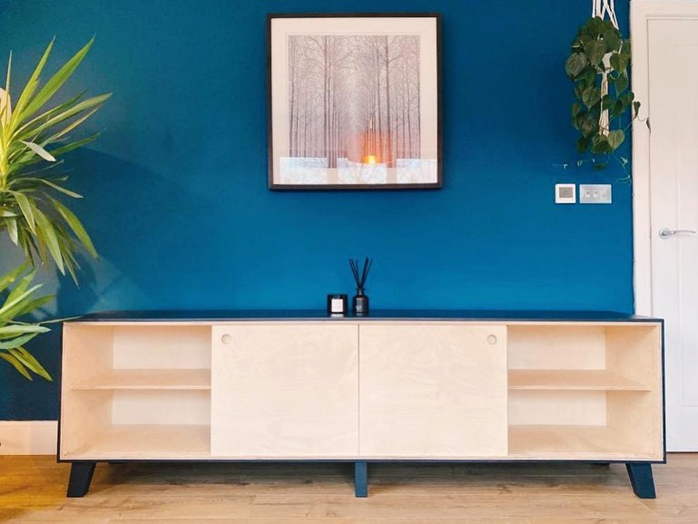 Inspiration for a medium sized modern open plan living room in Surrey with blue walls, laminate floors and a freestanding tv.