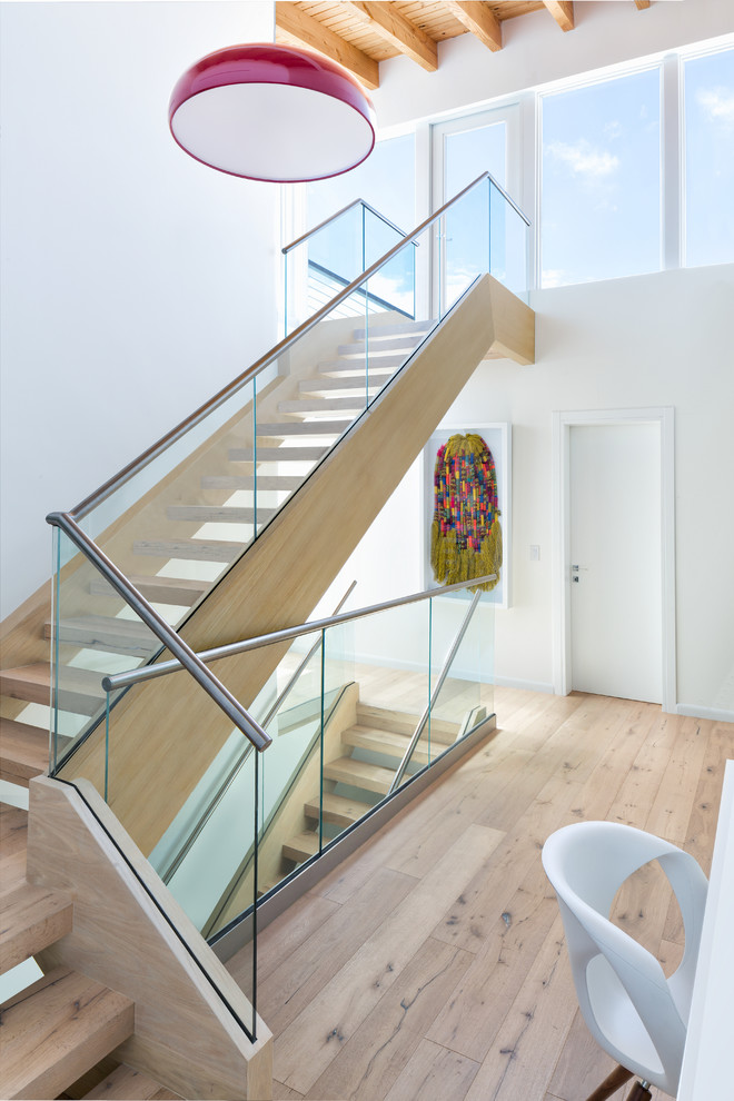 Example of a large beach style wooden l-shaped staircase design in Miami