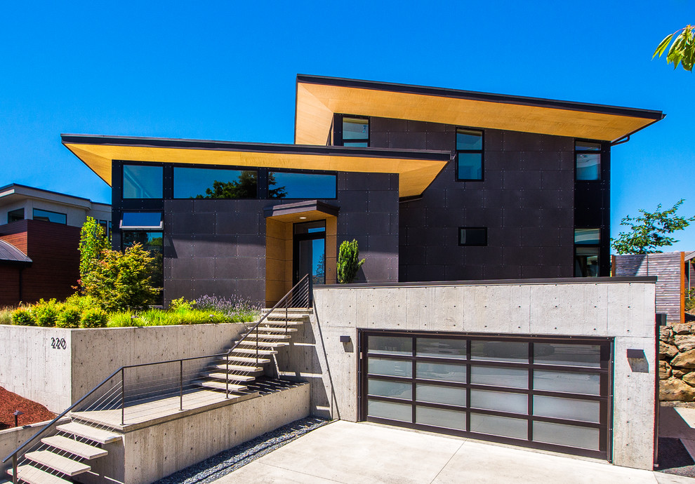 Photo of a mid-sized contemporary two-storey grey house exterior in Seattle with concrete fiberboard siding and a hip roof.