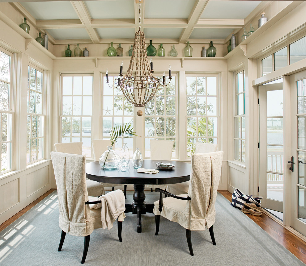 This is an example of a traditional separate dining room in Atlanta with dark hardwood floors and beige walls.
