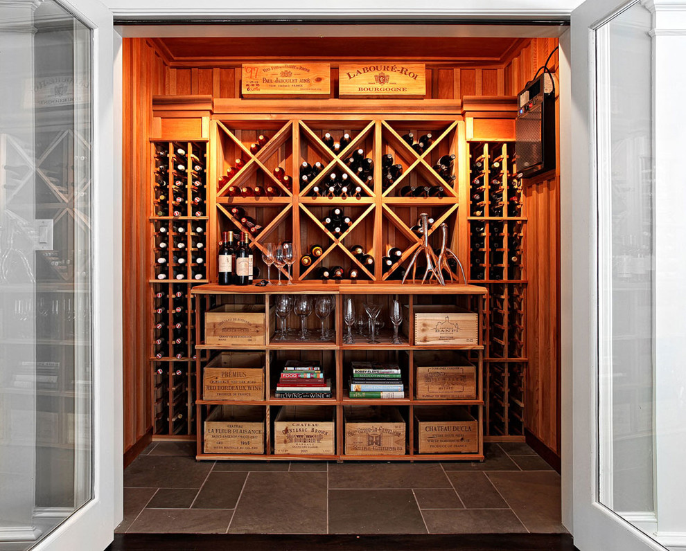 Transitional wine cellar in New York with diamond bins.