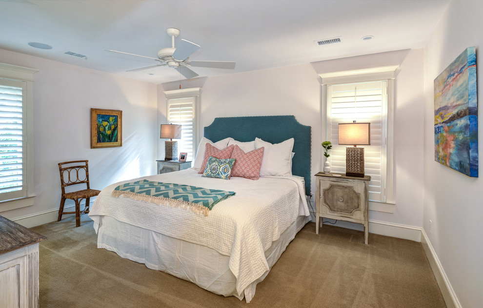 Inspiration for a large beach style guest bedroom in Charleston with white walls, carpet, no fireplace and brown floor.