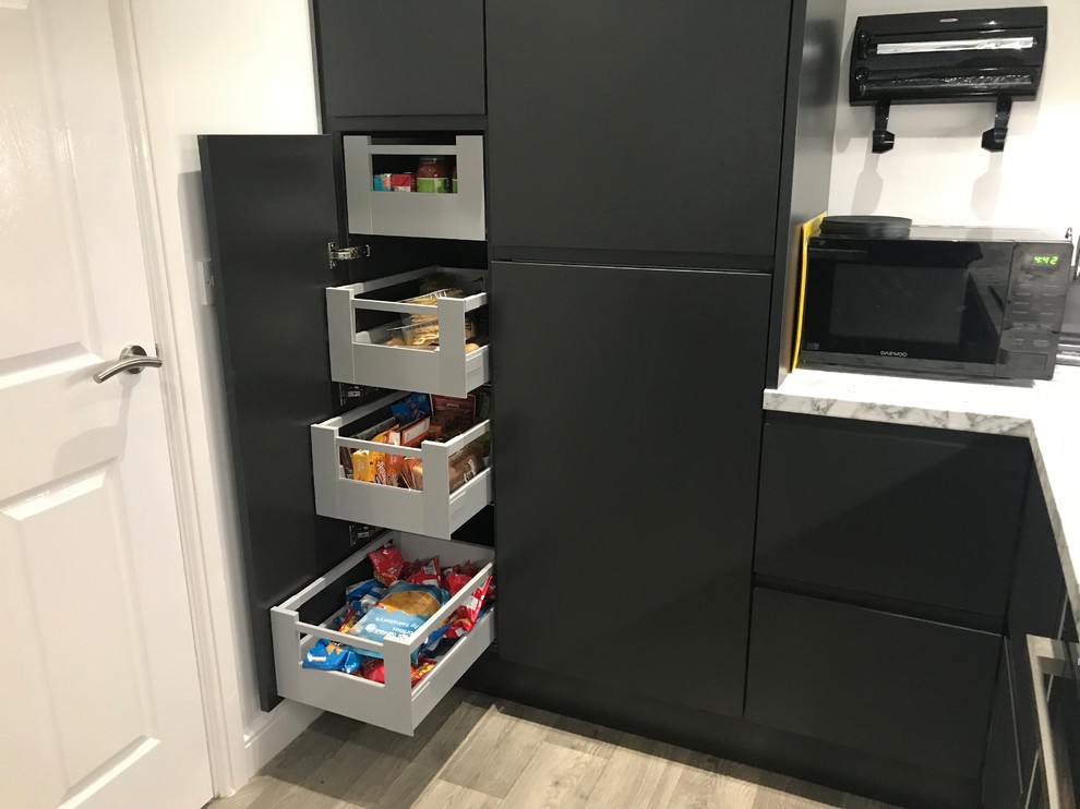 Photo of a small contemporary u-shaped separate kitchen in Buckinghamshire with flat-panel cabinets, grey cabinets, laminate benchtops, panelled appliances, no island and white benchtop.