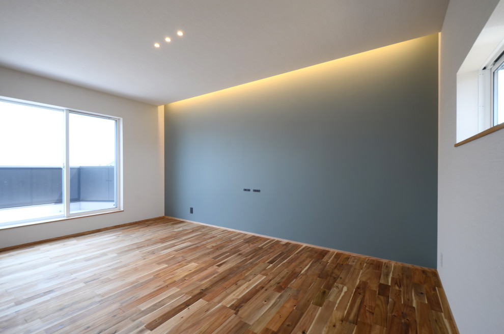 Inspiration for a mid-sized modern master medium tone wood floor, wallpaper ceiling and wallpaper bedroom remodel with white walls and no fireplace