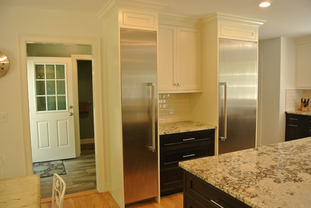 Eat-in kitchen - transitional light wood floor eat-in kitchen idea in Boston with an undermount sink, shaker cabinets, granite countertops, white backsplash, subway tile backsplash, stainless steel appliances and an island
