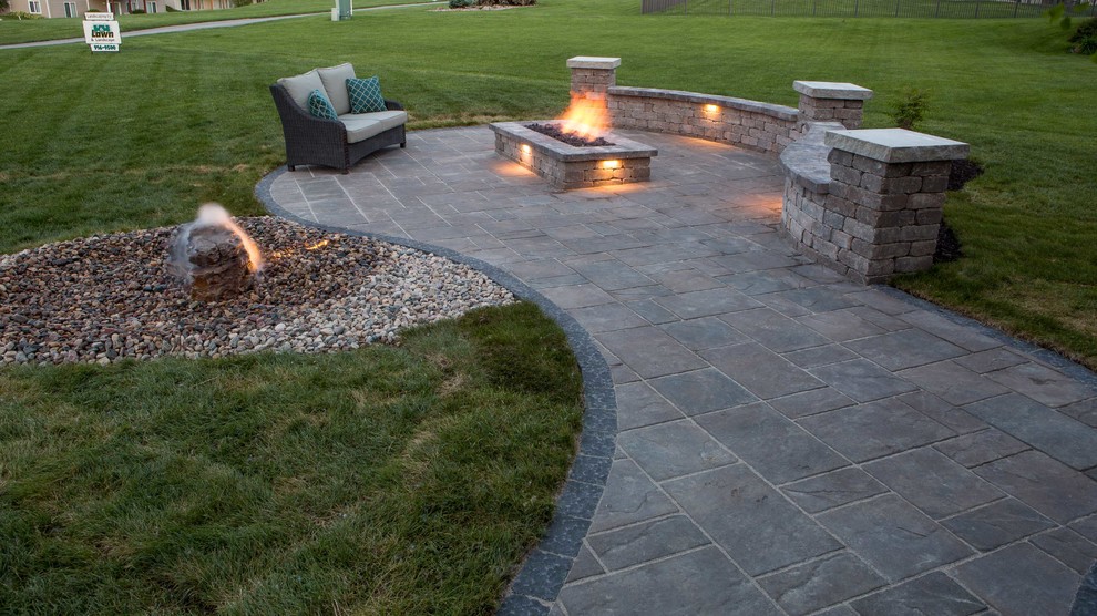 Mid-sized modern backyard full sun xeriscape in Omaha with a fire feature and brick pavers for summer.