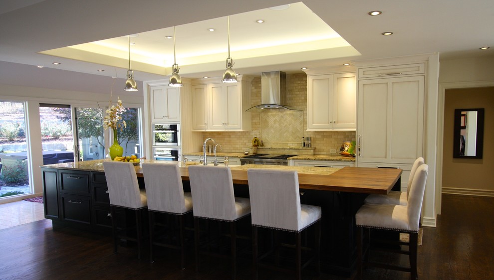 Large transitional single-wall dark wood floor and brown floor open concept kitchen photo in Kansas City with a farmhouse sink, recessed-panel cabinets, white cabinets, granite countertops, beige backsplash, paneled appliances, an island and multicolored countertops