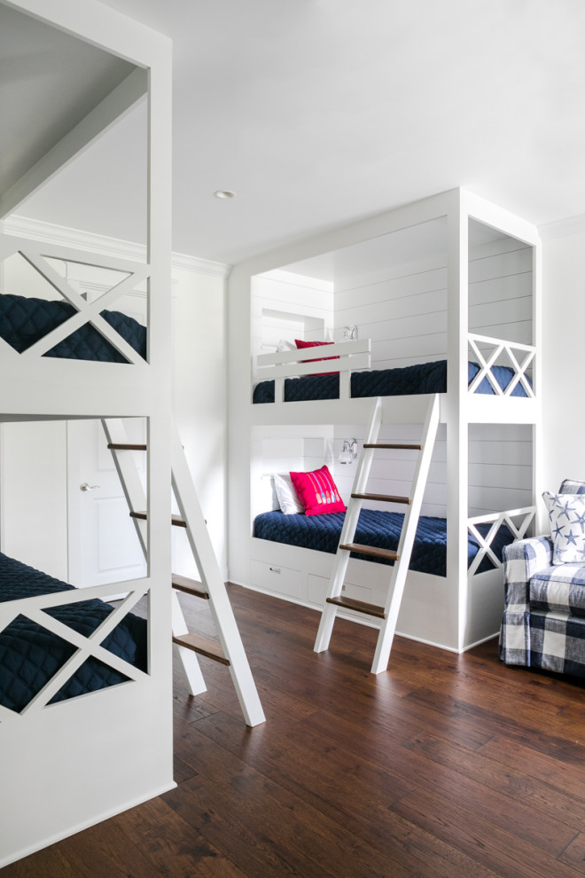 Photo of a mid-sized beach style gender-neutral kids' bedroom for kids 4-10 years old in Jacksonville with white walls, medium hardwood floors, brown floor and planked wall panelling.