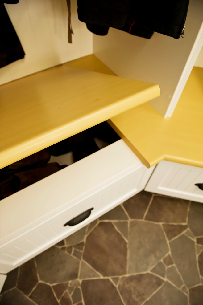 Inspiration for a small eclectic mudroom in Vancouver with yellow walls and vinyl floors.
