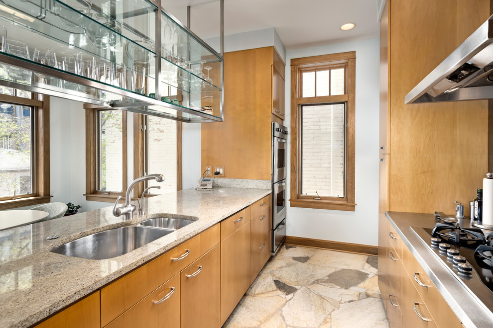 Mid-sized contemporary galley eat-in kitchen in Chicago with an undermount sink, medium wood cabinets, granite benchtops, stone slab splashback, stainless steel appliances and with island.