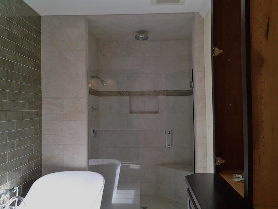 Freestanding bathtub - mid-sized master beige tile and stone tile freestanding bathtub idea with dark wood cabinets and beige walls