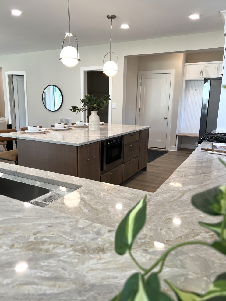 Kitchen - mid-sized transitional l-shaped beige floor kitchen idea in DC Metro with an undermount sink, shaker cabinets, white cabinets, quartz countertops, white backsplash, ceramic backsplash, stainless steel appliances, an island and beige countertops
