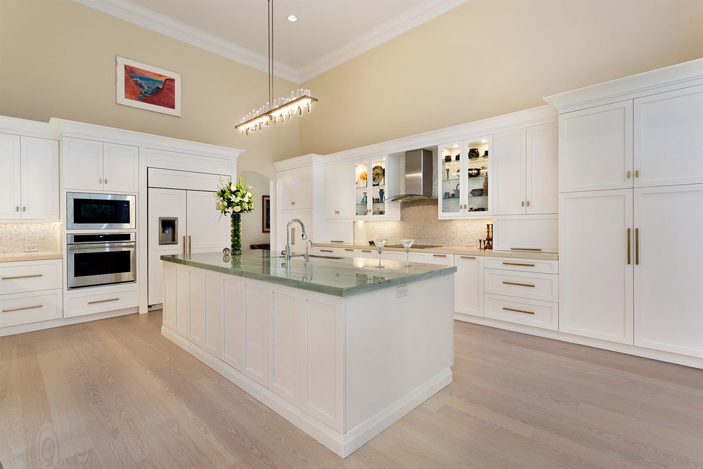 Enclosed kitchen - mid-sized transitional l-shaped light wood floor and beige floor enclosed kitchen idea in Miami with an undermount sink, recessed-panel cabinets, white cabinets, marble countertops, beige backsplash, mosaic tile backsplash, stainless steel appliances, an island and multicolored countertops
