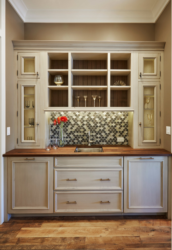 Inspiration for a small transitional single-wall wet bar in Miami with an undermount sink, grey cabinets, wood benchtops, recessed-panel cabinets, multi-coloured splashback, mosaic tile splashback, medium hardwood floors, brown floor and brown benchtop.