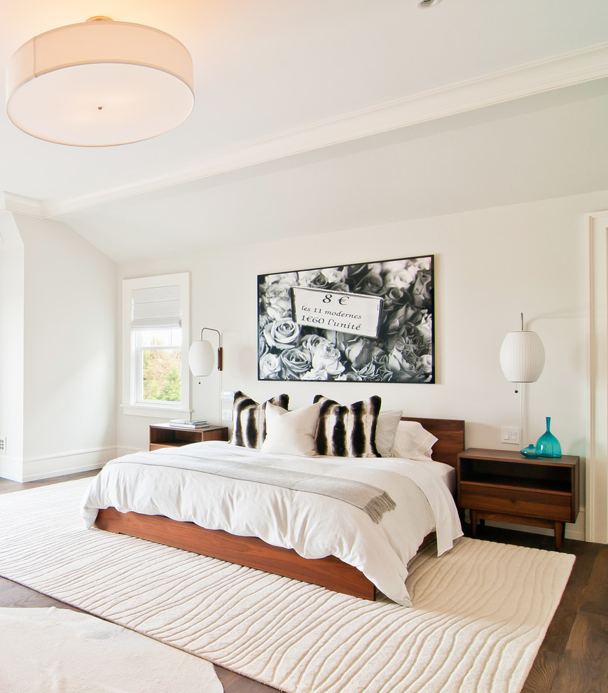 Contemporary bedroom in New York with white walls and dark hardwood floors.