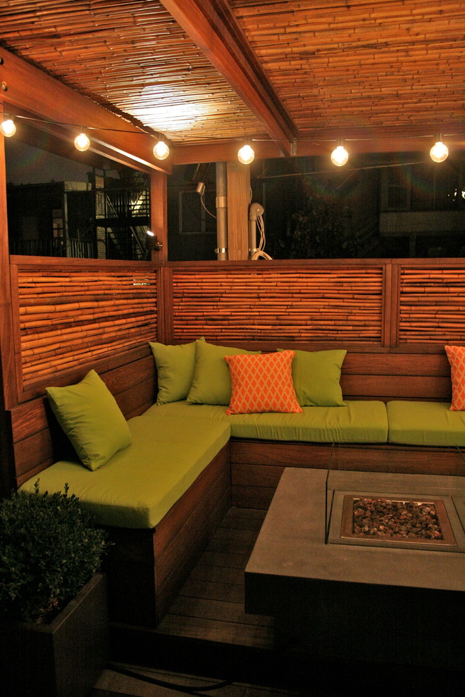 This is an example of a mid-sized eclectic rooftop garden in Chicago with a fire feature and decking.