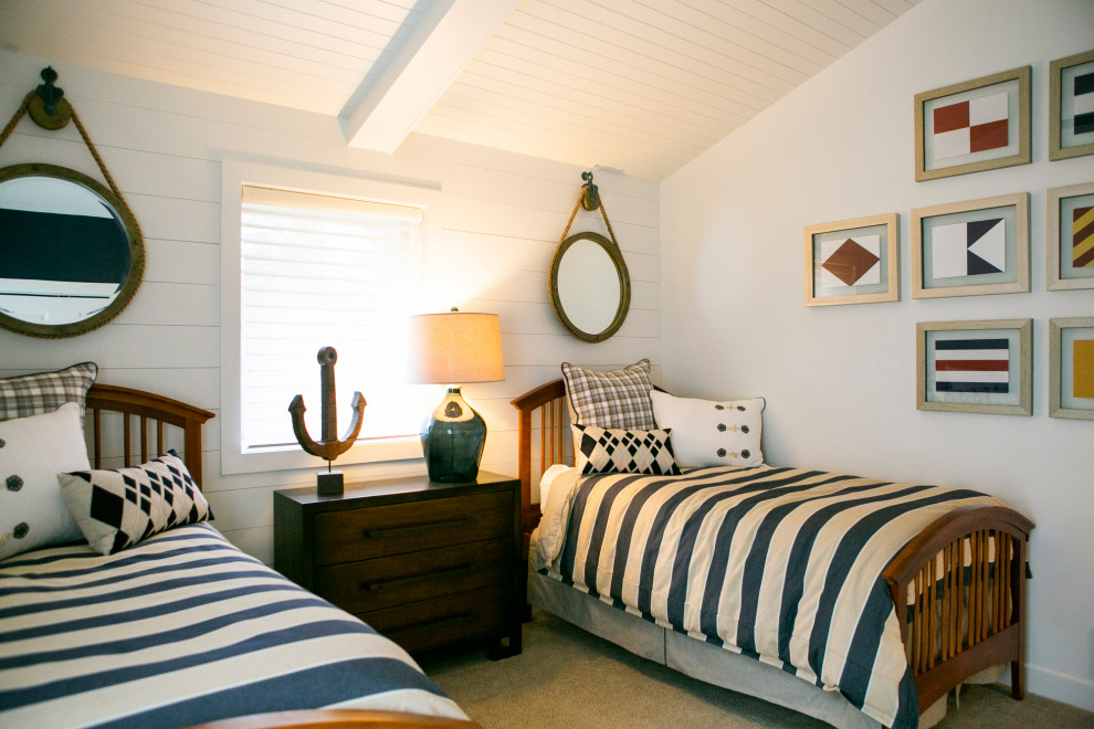 Photo of a beach style gender-neutral kids' bedroom for kids 4-10 years old in Other with white walls, carpet, beige floor, timber and planked wall panelling.
