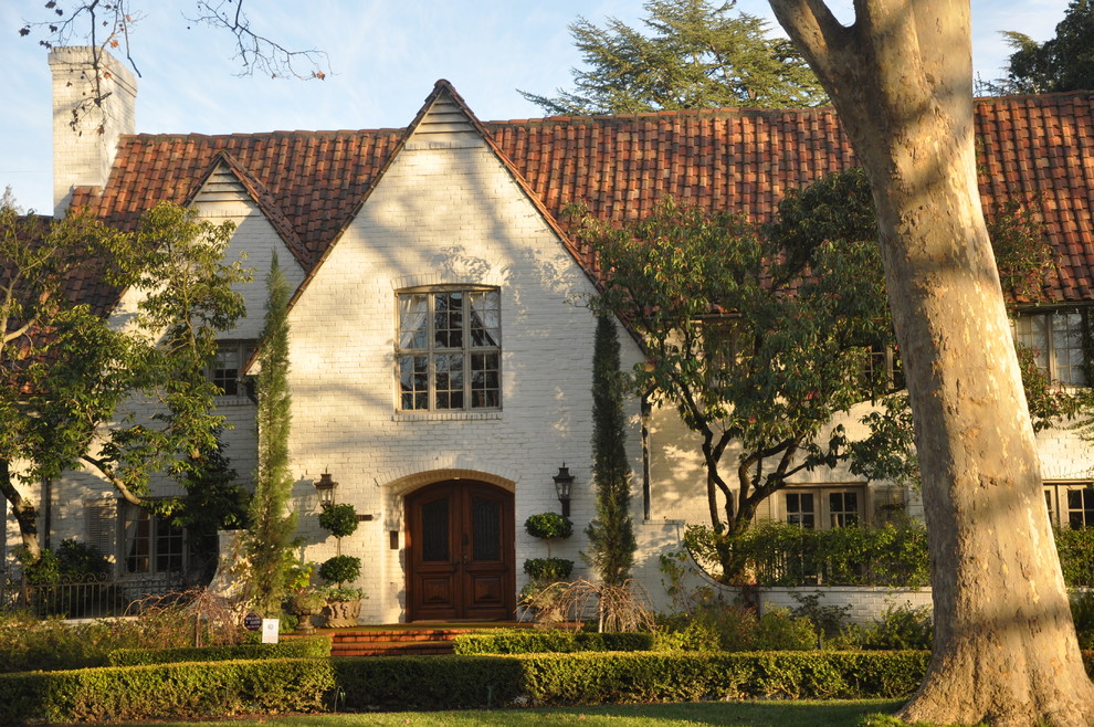 Photo of a traditional two-storey brick exterior in Sacramento with a gable roof and a tile roof.